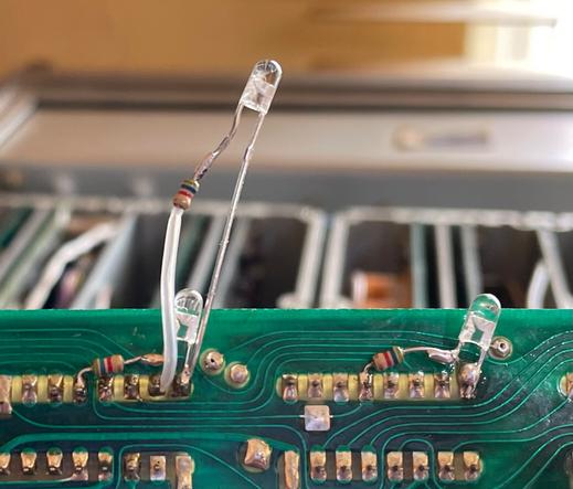 LEDs and current limit resistors soldered to the underside of a PCBA