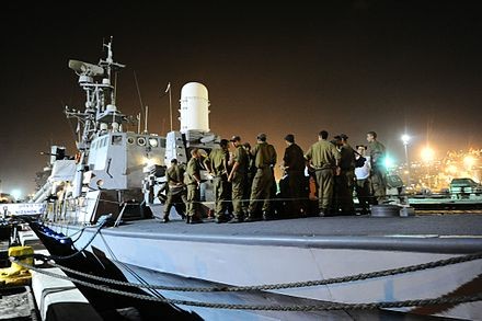 The INS Nitzachon at Haifa naval base being readied for the operation. By Israel Defense Forces - Israeli Navy Preparing for Flotilla Operation, CC BY 2.0, https://commons.wikimedia.org/w/index.php?curid=34371824