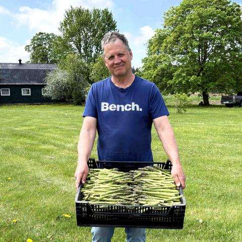 Tim Barrie, holding a just picked crate of asparagus
