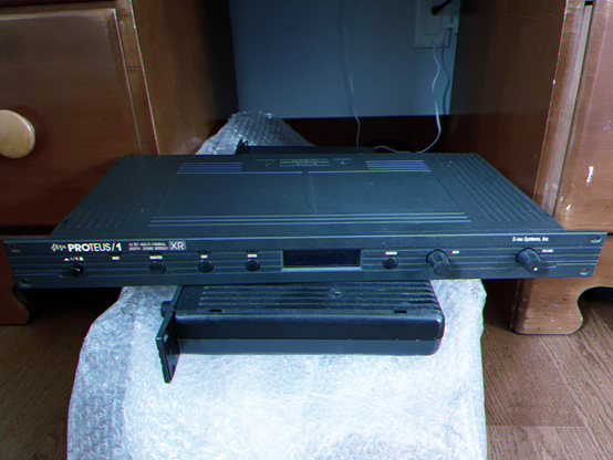 An E-mu Proteus 1 XR with a rare Protologic board installed, sitting on top of some other old equipment