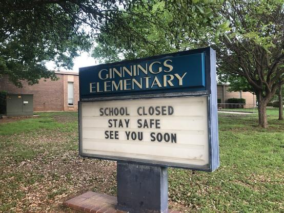 Sign: GINNINGS ELEMENTARY SCHOOL CLOSED STAY SAFE
 SEE YOU SOON