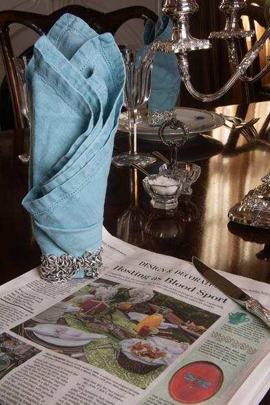 Xover0's Ancient Courses Napkin Rings featuring seven historic routes of the Mississippi River are photographed with that day's Wall Street Journal. The newspaper is open to an article discussing the art of table setting. The story stresses the importance of unique personal finds over mainstream brands from typical retailers, stating: "It’s a sport scored on originality and style."