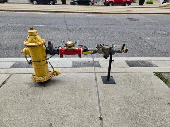 a fire-hydrant with many adapters on it