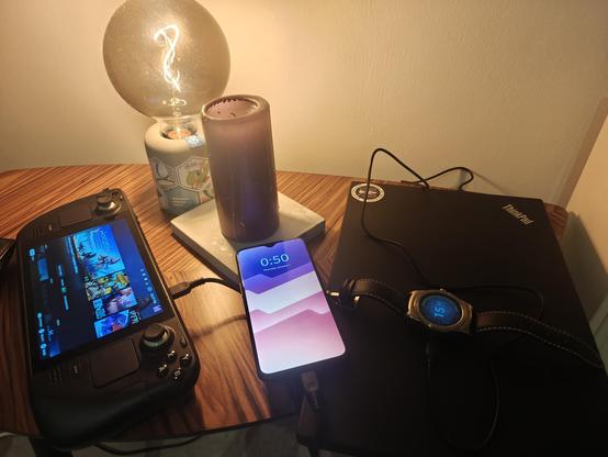 Picture of a closed laptop, a steam deck, a one plus 6t running plasma mobile and a watch running asteroid OS