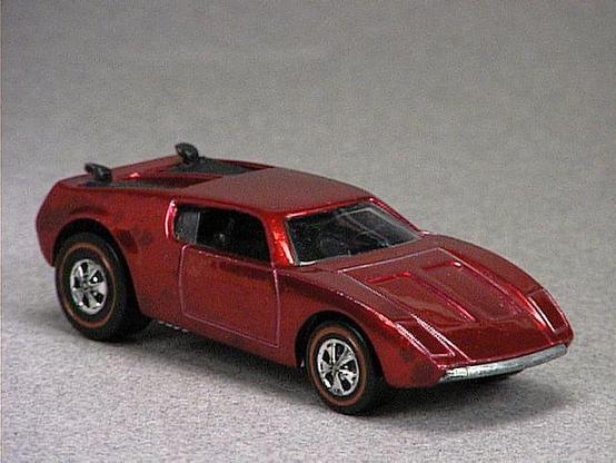 Released in 1971, Spectraflame Red AMX/2 of 1971 Hot Wheels with Redline wheels. Notes: Has two black plastic pop-up engine covers. Packaging: 1971 Blister. Metal Body, Metal Base. Made in USA. Scarcity: 5/10