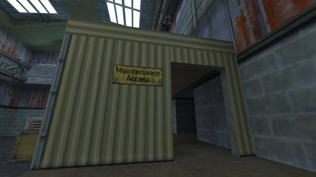 In this picture you can see the bright yellow corrugated iron building from near and from the other side. From left to right, you can see a ventilation shaft in the background, a wooden box, and the bright yellow corrugated iron building. At this wm there is an entrance on the right and to the left of it hangs a yellow sign with the phrase Maintance Access in black. In addition, you can see the steel girders and the two windows in the roof on the left and right under the roof. This is on the map de_nuke in the game Counter-Strike 1.6.