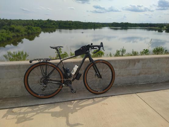 Bicycle leaning against a short stone wall overlooking the reservoir at Lakeline Park in Cedar Park, TX.