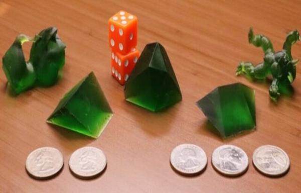 a selection of single 3D printed dice with weird shapes