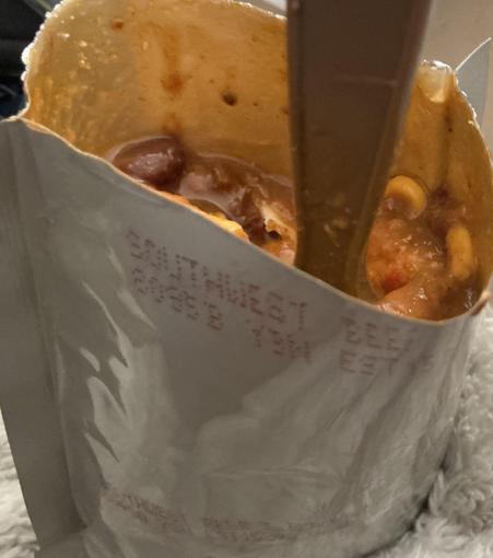 A very tasty southwest beef & black beans meal in it’s pouch along with the supplies spoon & garlic naan bread bits I added.