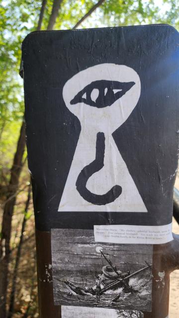 color photo of wheat paste art found on bridge - eye what?