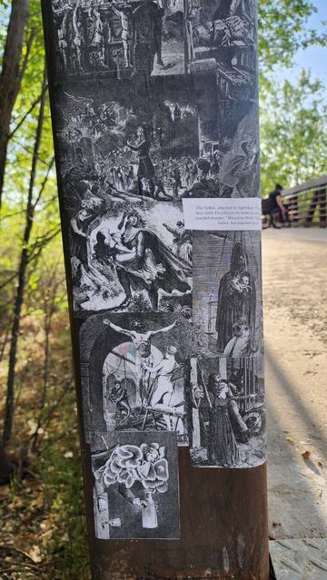 color photo of wheat paste art found on bridge - black and white what?