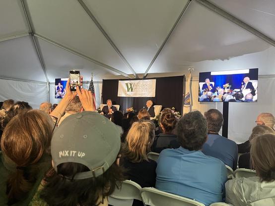 A photo of a talk with Justice Breyer and Douglas Brinkley. We are in a tent outdoors. There are two monitors (one on each side) making it easier to see from the crowd