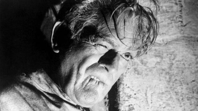 Boris Karloff, with a twisted face, as James Rankin in The Haunted Strangler (1958)