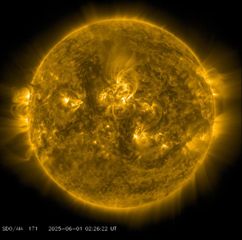 Solar disc showing turbulent and twisted plasma and gas in the solar surface. Near the centre there is a bright feature in the same location as sunspots.
