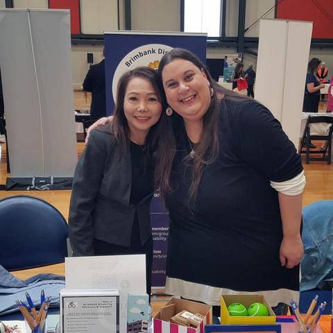Two women, showcasing the Brimbank Disability Advocacy & Support group, standing behind the table at the expo. The woman on the left, Mayor Dang, is Vietnamese, wearing a dark gray jacket. Shannon is standing on the right.
A large banner behind them displays the Brimbank Disability Advocacy & Support (BDAS) logo and information about the community group, noting that it is for people with disability or neurodivergence, aiming to connect, support each other, and seek inclusion.
The stall has a welcoming appearance and conveys the message of support and accessibility for people with disability or neurodivergent individuals.