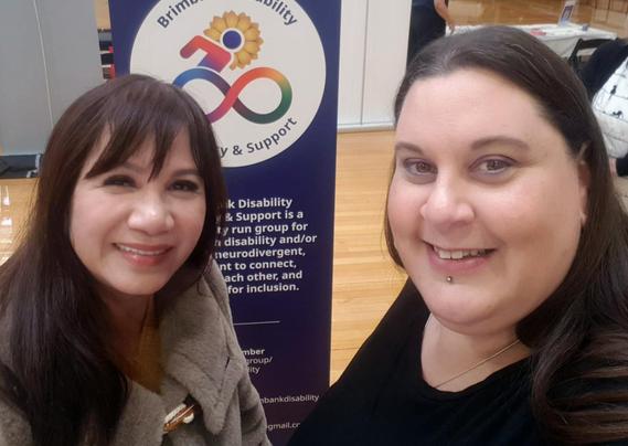 Two women are smiling and posing for a selfie photo. The woman on the left, Councillor Truong, is Vietnamese, has long brown hair and is wearing a fluffy, light grey jacket. She has a big, warm, smile. Shannon stands to her right.