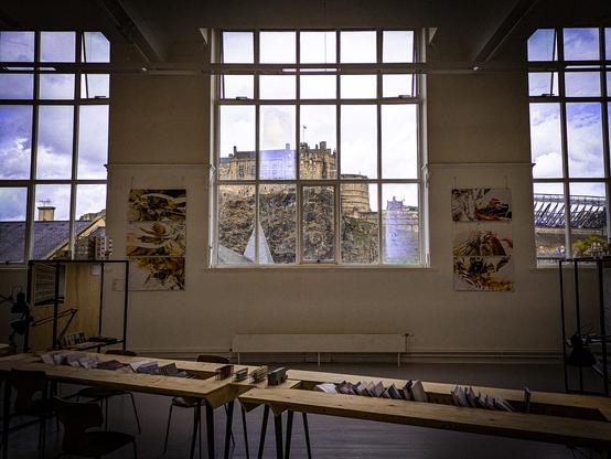 Three large windows in an art studio. They frame Edinburgh Castle.