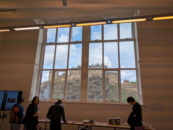 A large window in an art studio framing Edinburgh Castle.