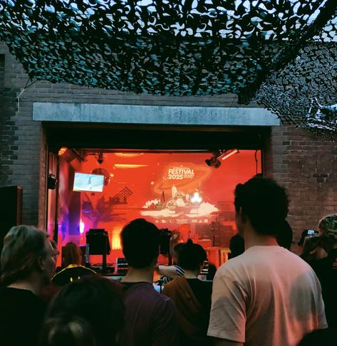 People outside next to the Panama Racing Club stage, watching Computerdisco playing live