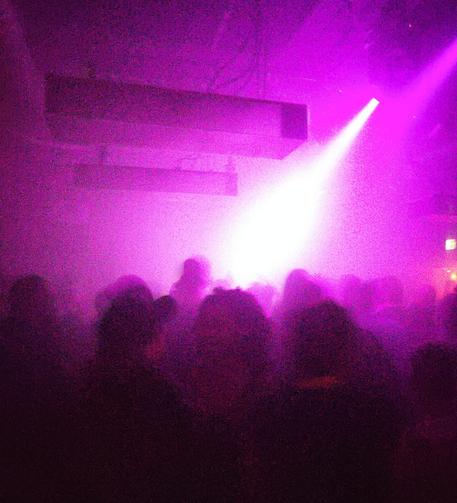 Crowd, lights and smoke in a blurry photo