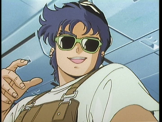 Sup Dude! It's Kento in a brown overalls, white tee, black hat, and some green plastic shades. He's got a goofy smile on his face.