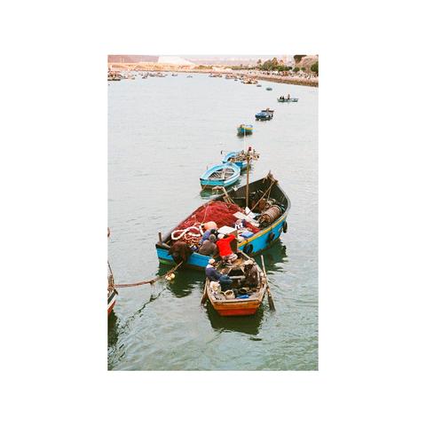 View of fishermen in their boats at the harbor in Rabat, Morocco