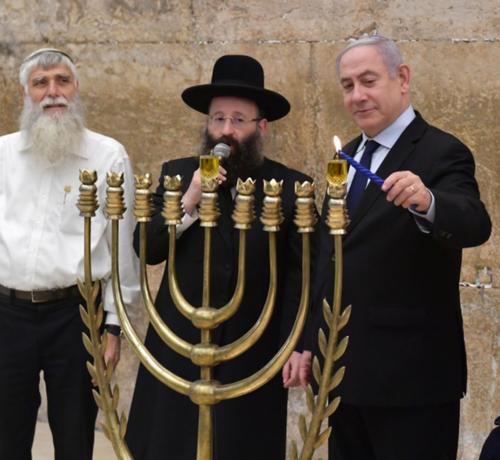 Evil mass murder and child eliminator terrorist Netanyahu with some Hascidic jewish terrorists and a minorah at the wailing wall