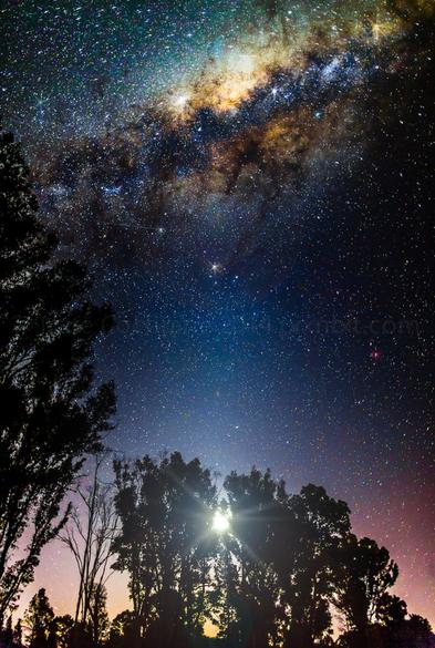 Milky Way ascending over rising full moon.