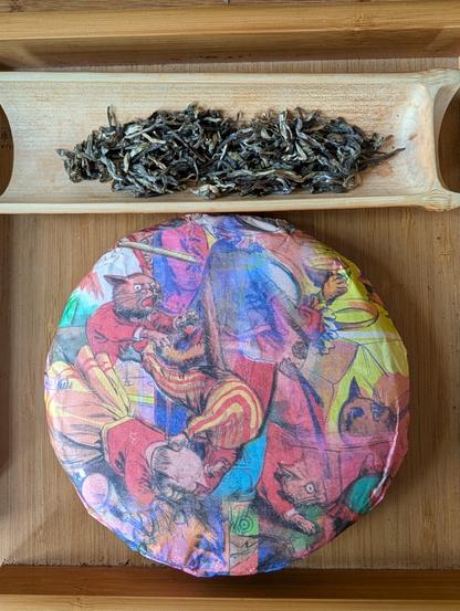 Puerh tea cake in wrapper next to dry tea leaves