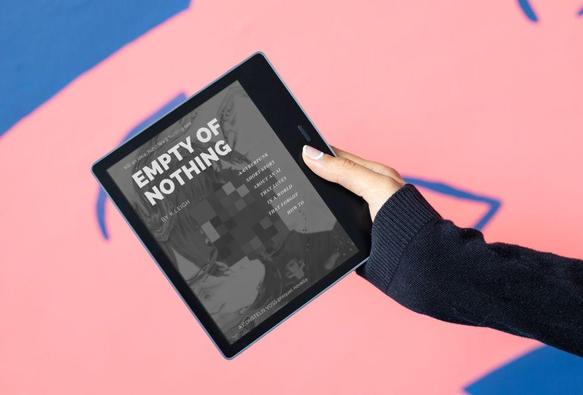 a mockup of a person's hand holding an eBook entitled EMPTY OF NOTHING. the background is pink and blue.