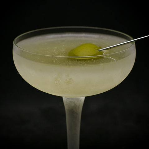 The cocktail itself in a chilled coupe and garnish with an olive