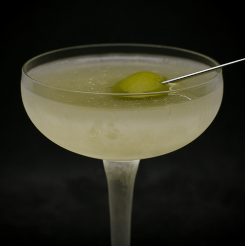 The cocktail itself in a chilled coupe and garnish with an olive