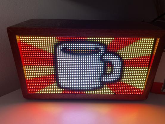 The same screen showing a cartoon coffee cup with a red and yellow background