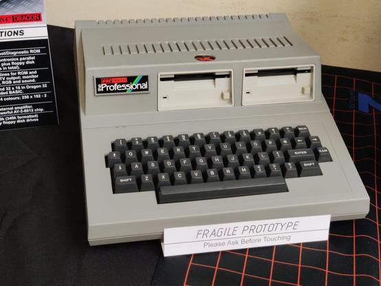 The only working GEC Dragon "The Professional" in the world. There are a handful of other known examples, none of which work.

The machine is a sober mid-grey, with the rear part of the case raised to accommodate two full-height 3½ inch floppy disk drives. It looks very serious and professional. Sadly Dragon Data went bust before the machine came to market.

This machine, along with related marketing photos and graphics, was donated to Richard by the last managing director of Dragon Data.