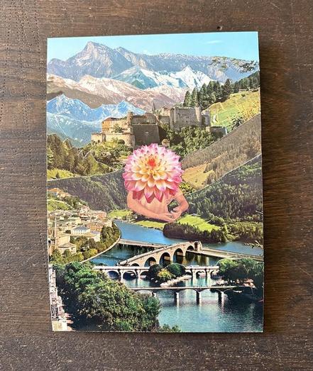 A collage of vintage souvenir postcards featuring various landscapes — mountains, castles, villages, and a river with several bridges.  At the center is the upper torso of a woman, her head replaced by a vivid pink and white dahlia bloom.