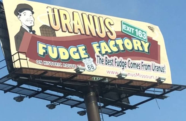 Photo of a billboard for Uranus Fudge Factory which reads, "The best fudge comes from Uranus."