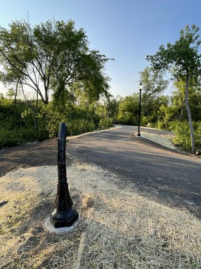 Broken street lamp along path