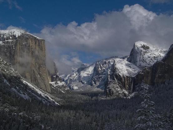 Snow Kissed Valley

This shot was taken as a winter storm was clearing the valley. The morning was cold and nasty but as the day moved on the sun started to break through.
On the left is El Capitan in it's proud glory. On the right you have Bridalveil Falls, The Three Brothers, and in the center back is Half Dome.
This is one of the most popular vistas in Yosemite but very rarely seen by most during the winter.
Bridalveil Falls drops roughly 800 feet from the crest of the falls to the valley below. El Capitan rises 3,000 feet from the valley floor. Tunnel view splits those distances and allows a straight shot down the valley.