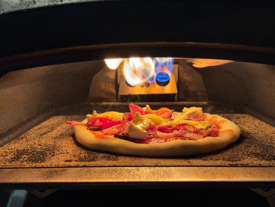 Pizza inside a small ooni pixza oven