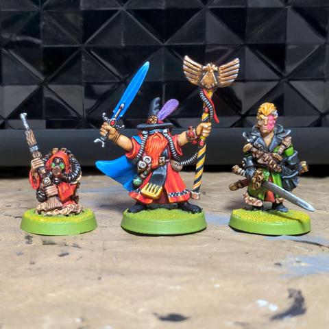 The two characters from the first image stood either side of Jeph the Space Wizard, with his blue sword, red flowing robes, blue cloak and yellow and black stripy psychic staff topped with a golden eagle.