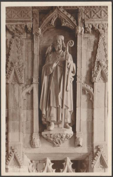 Sepia real photographic postcard showing a view of the statue of St David in St David's Cathedral in Pembrokeshire.

Published by Mendus, St David's, not numbered, c.1930s.

Postally unused.

Very good condition, with minimal corner bumps and light album marks, otherwise excellent.