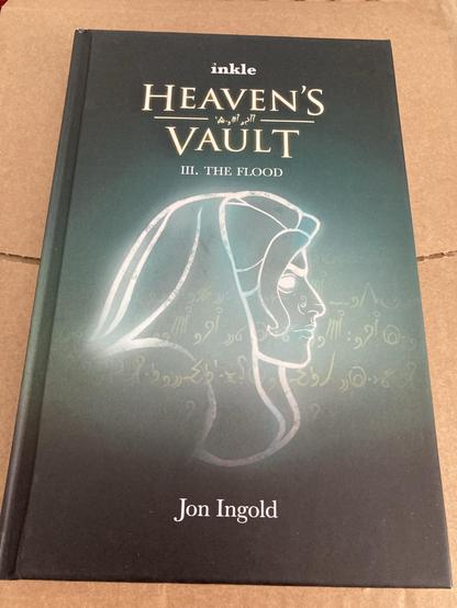 Heaven’s Vault: Book 3 (III) The Flood hardback book by Jon Ingold.
Cover image an ancient goddess (?) and faint writing in the ancient text from the video game