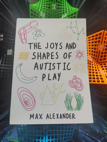 The cover of the book, with colourful doodles of an impossible triangle, various rays, structures, tangles and whatnot. And a banana.