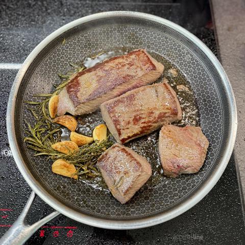 The lamb fillets in the frying pan just before they go into the oven.