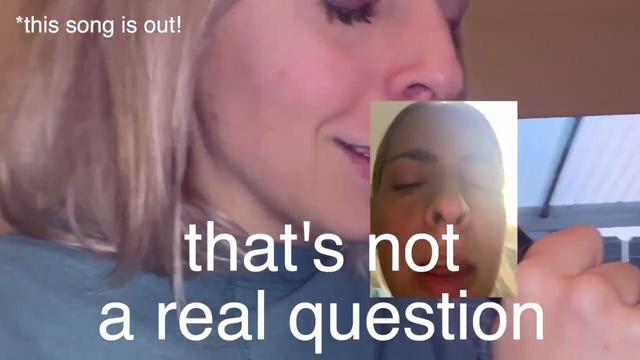 The thumbnail from Julia Nunes' kickstarter announcement video for Julia Nunes is perfect. The image features two images of Julia's face. Both images have her eyes closed. The background image shows heer facing away from the camera holding what appears to be a microphone. The image above that is in place of the microphone and is a close up shot where she has her eyes closed. The text on the image says 'this song is out' and including the text 'that's not a real question' which is a lyric from 'Your favorite'.