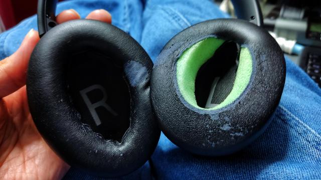 Headphones with worn ear pads. One is completely falling apart because a single seam failed somehow on the inside!