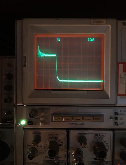 The display of an analogue oscilloscope, showing a pulse with a 'ringing' oscillation on top.