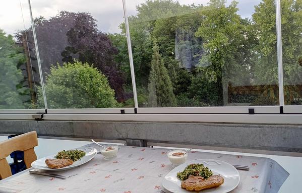 Der Eßtisch im Wintergarten ist gedeckt.