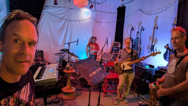Picture of four people holding musical instruments