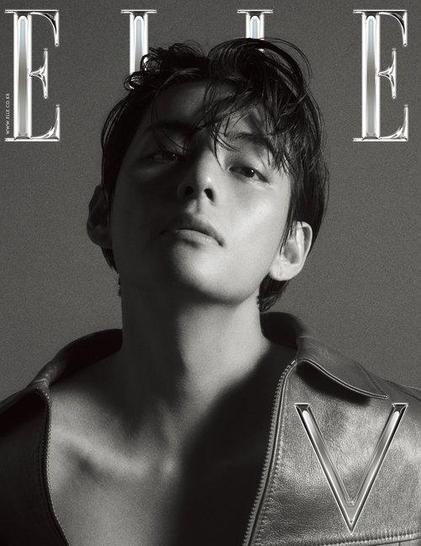 V of BTS on the monochrome greyscale cover of ELLE Korea. It shows him with his head slightly back, lips slightly parted, looking at the camera. He is wearing an open leather jacket without a shirt underneath.